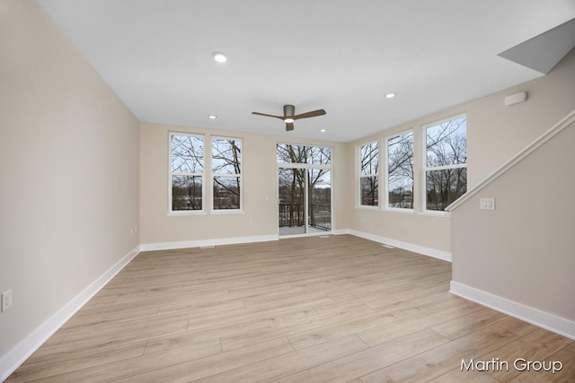 unfurnished living room featuring ceiling fan and light hardwood / wood-style floors