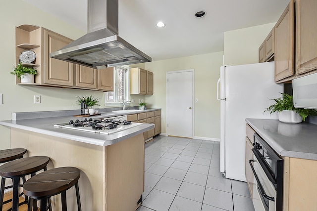 kitchen featuring island exhaust hood, a breakfast bar area, open shelves, white appliances, and a peninsula