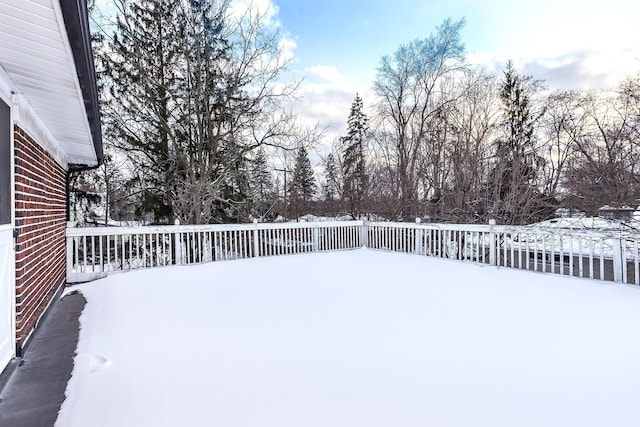 snowy yard with a deck