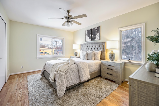 bedroom featuring baseboards, ceiling fan, and light wood-style floors