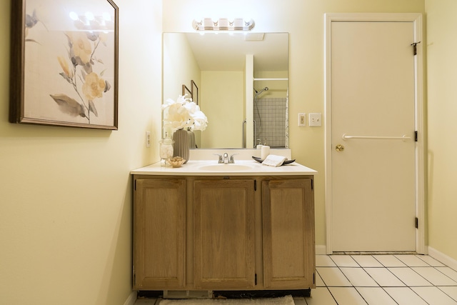 full bath featuring tile patterned flooring, baseboards, and vanity