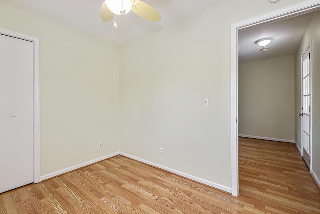 unfurnished bedroom featuring light wood finished floors, baseboards, and a ceiling fan