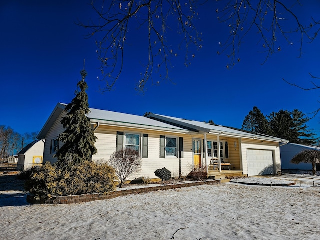 ranch-style home featuring a garage and covered porch