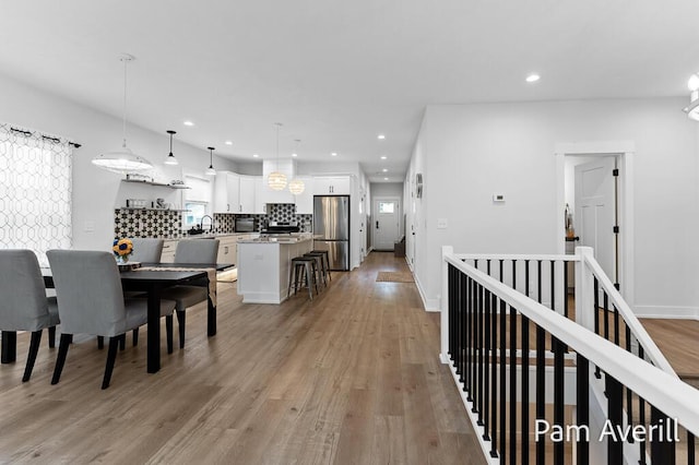 dining area featuring sink and light hardwood / wood-style floors