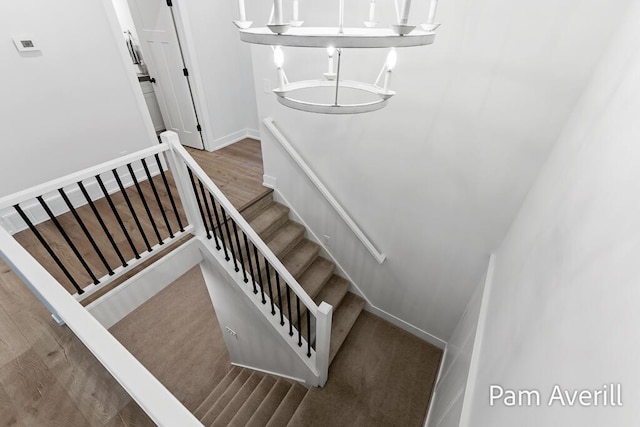 stairs featuring hardwood / wood-style floors