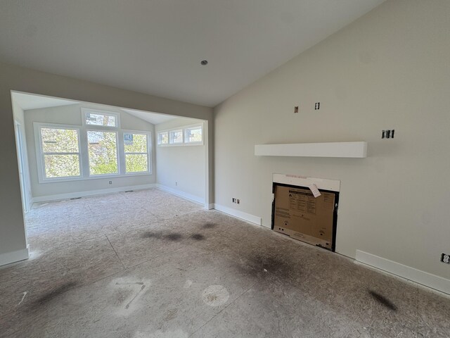 275 Hickory Valley Dr, Kalamazoo, MI 49009 - unfurnished living room featuring baseboards and vaulted ceiling