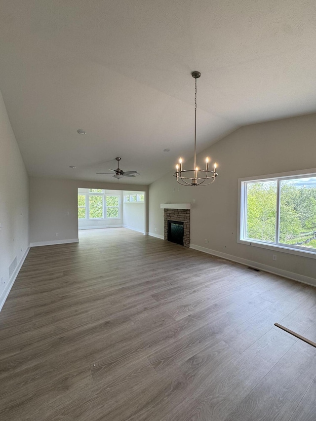275 Hickory Valley Dr, Kalamazoo, MI 49009 - unfurnished living room featuring baseboards, wood finished floors, a chandelier, and vaulted ceiling