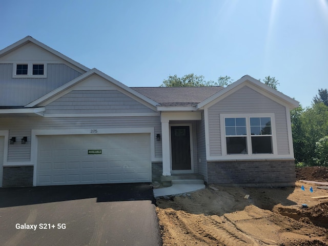 275 Hickory Valley Dr, Kalamazoo, MI 49009 - view of front of property with asphalt driveway, a garage, and brick siding