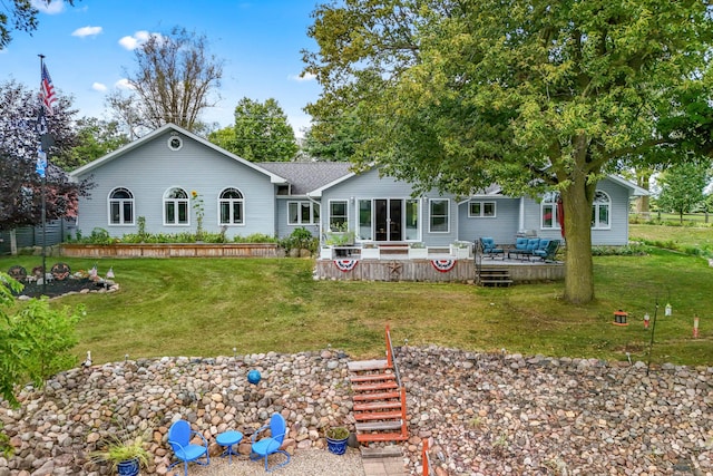 rear view of house with a wooden deck and a yard