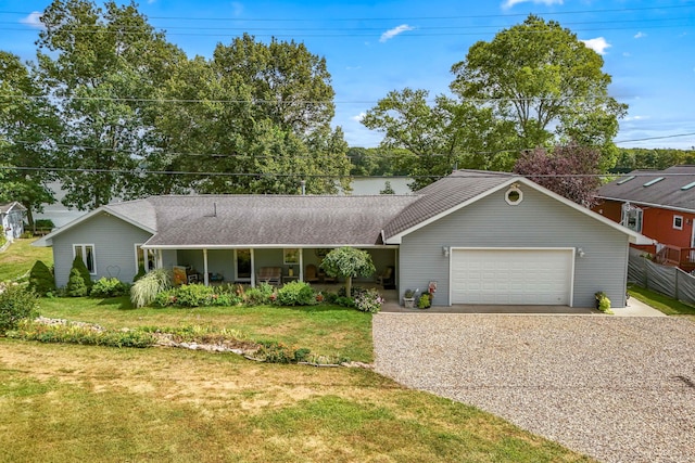 ranch-style house with a garage, covered porch, and a front lawn