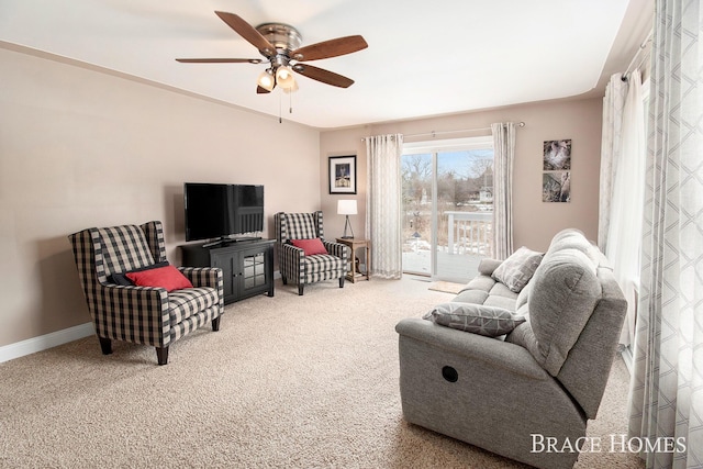 carpeted living room featuring a ceiling fan and baseboards