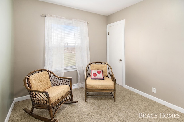 sitting room with carpet flooring and baseboards