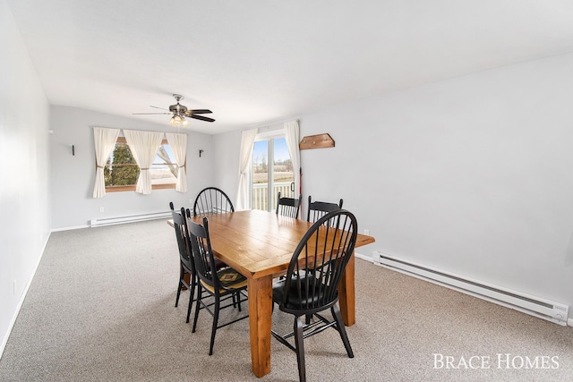 dining area with a baseboard heating unit, ceiling fan, carpet, and baseboards