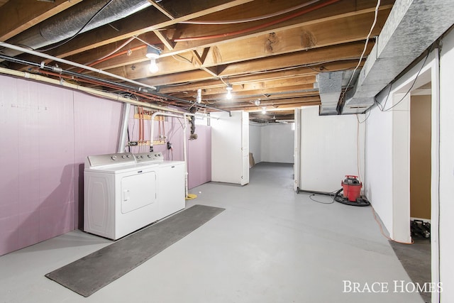 unfinished basement featuring washing machine and dryer