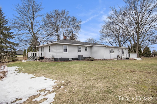 back of house with a chimney, a lawn, cooling unit, and a wooden deck