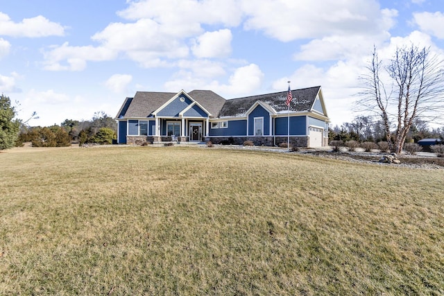 view of front of home with a garage and a front lawn