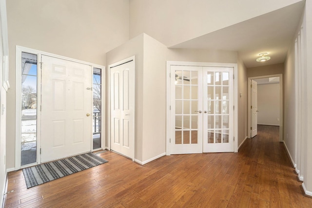 foyer entrance featuring a wealth of natural light, wood-type flooring, and french doors