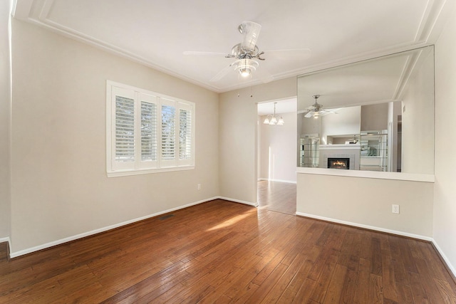 unfurnished room with wood-type flooring and ceiling fan with notable chandelier