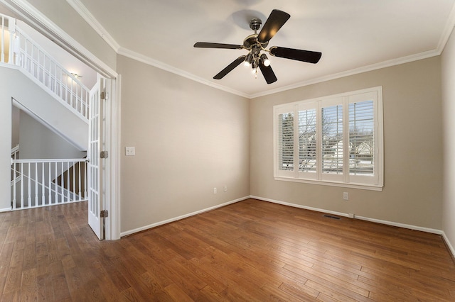 empty room featuring ornamental molding, hardwood / wood-style floors, and ceiling fan