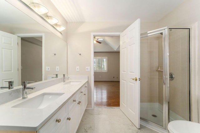 bathroom featuring ceiling fan, vanity, and an enclosed shower