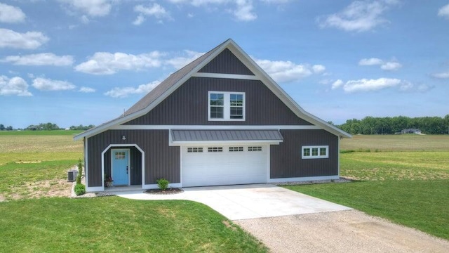 view of front of property with a garage, a front yard, and a rural view