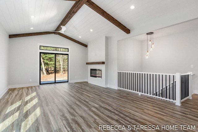 unfurnished living room with hardwood / wood-style flooring, a large fireplace, and vaulted ceiling with beams