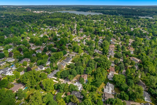 aerial view featuring a residential view, a water view, and a wooded view