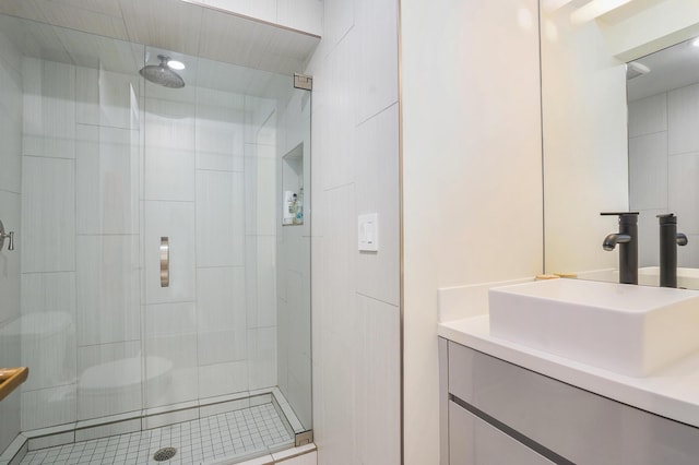 bathroom with a stall shower and vanity