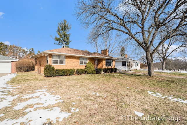 ranch-style home with a garage and a front lawn