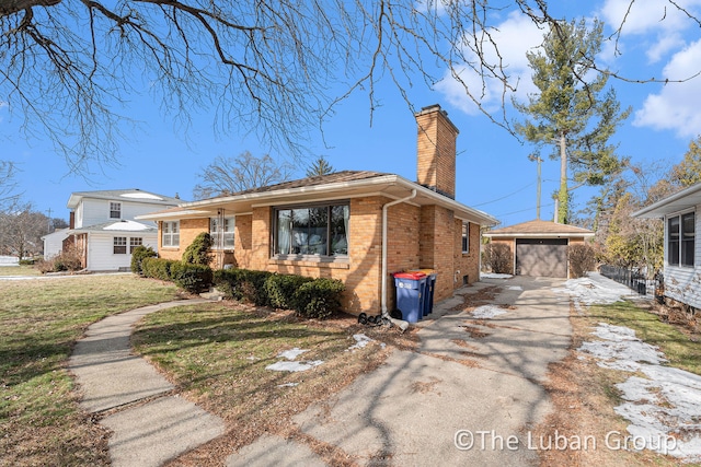 view of front facade with a garage, an outdoor structure, and a front yard