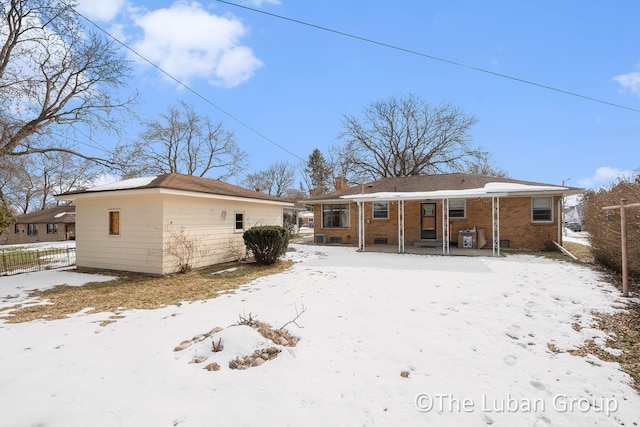 snow covered house with covered porch