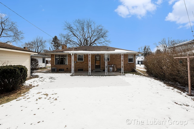 snow covered property featuring central air condition unit