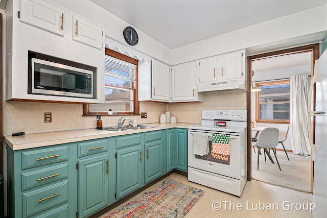 kitchen with white cabinetry, white appliances, sink, and tasteful backsplash