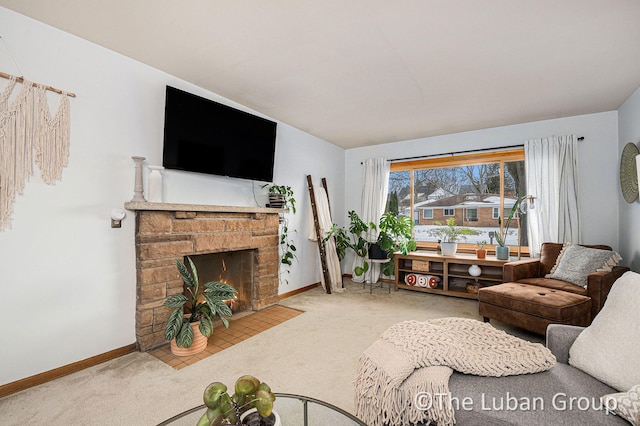 living room featuring a stone fireplace and carpet