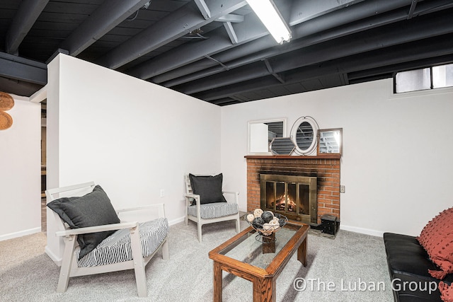 carpeted living room with a brick fireplace and beamed ceiling