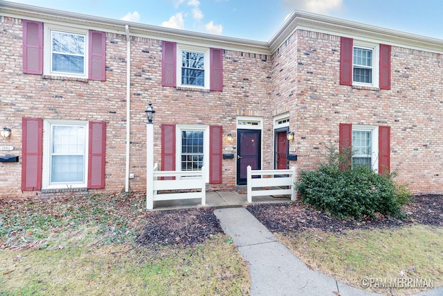 townhome / multi-family property featuring brick siding