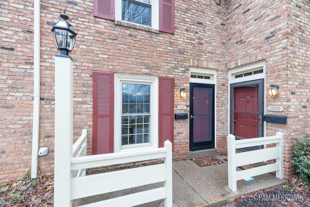 property entrance featuring brick siding