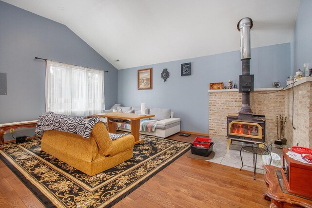 37076 76th St, Covert, MI 49043 - living room featuring wood finished floors, a wood stove, and lofted ceiling