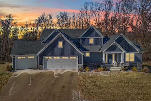 view of front of property featuring a garage and a lawn