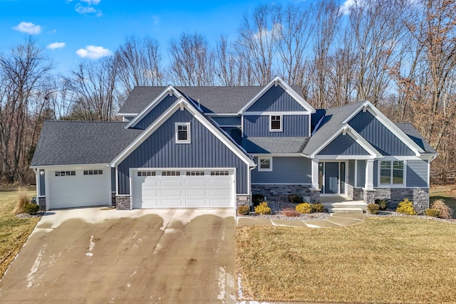 craftsman-style house featuring a garage and a front lawn