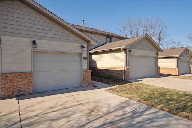 view of side of home featuring a garage and an outdoor structure