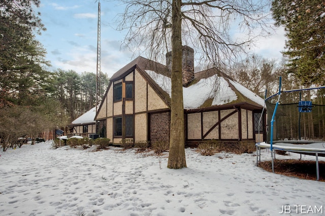 snow covered property with a trampoline