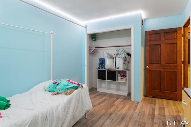 bedroom featuring light wood-type flooring and a closet