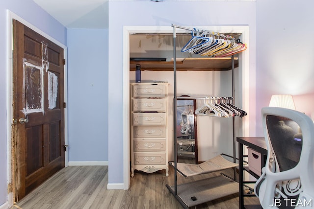 interior space featuring light wood finished floors and baseboards