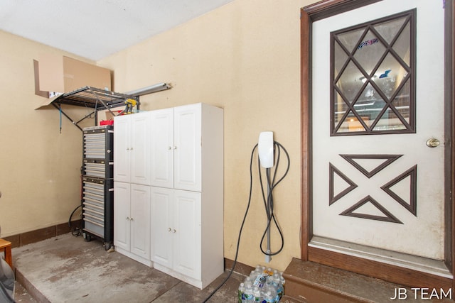 interior space with concrete flooring and baseboards