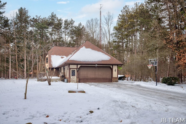 exterior space featuring a garage and a wooden deck