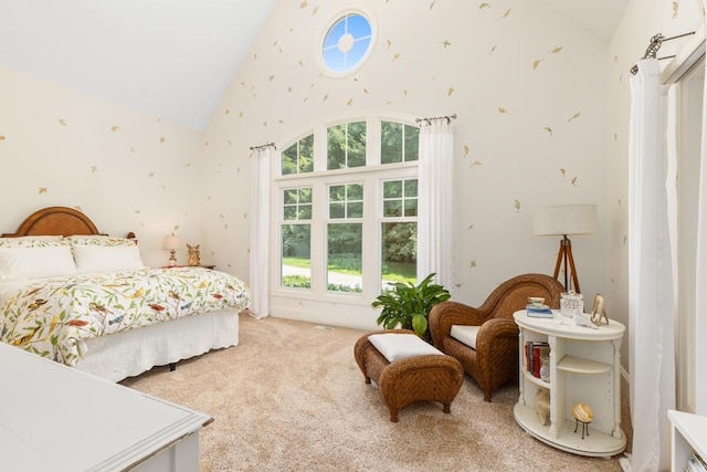 bedroom with light colored carpet and high vaulted ceiling