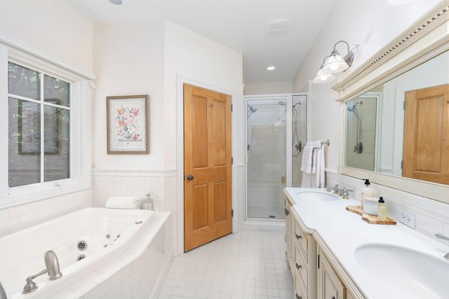 bathroom with independent shower and bath, vanity, and tile patterned floors