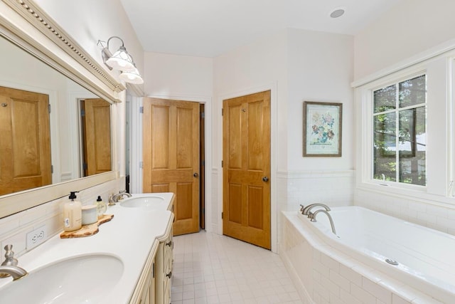 bathroom featuring vanity and tiled bath