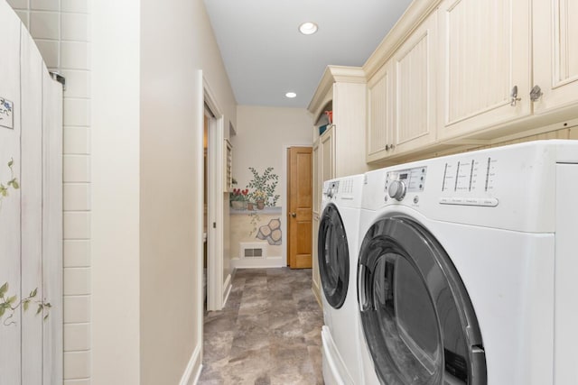 laundry room with cabinets and washing machine and clothes dryer